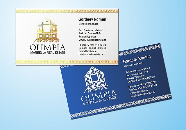 На фото визитка компании Olimpia. На ней изображен дом из золотых снимков.